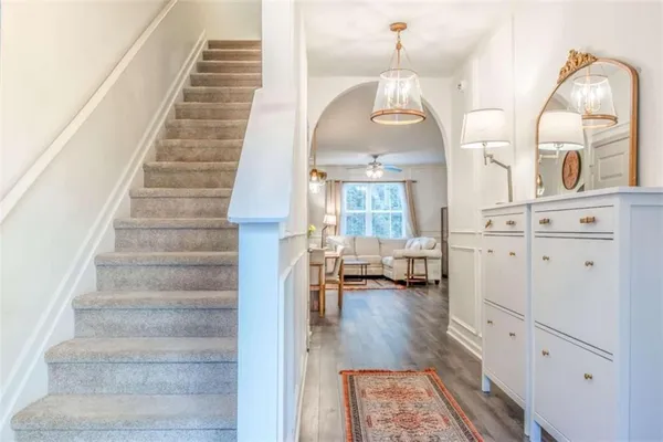 a view of entryway and hall with wooden floor
