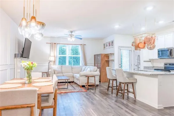 a living room with fireplace furniture and a wooden floor