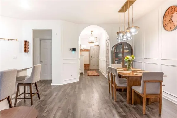 a view of a dining room with furniture and wooden floor