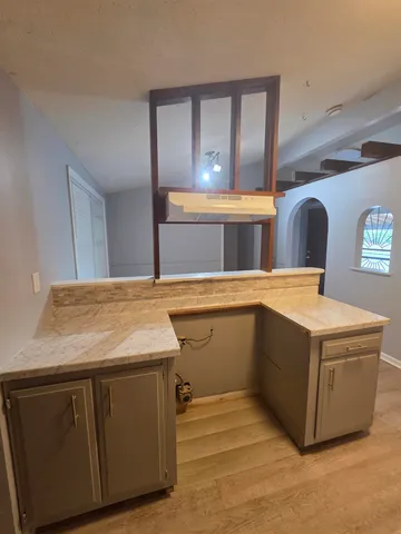 a kitchen with stainless steel appliances granite countertop a sink and a stove