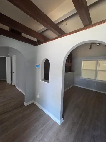 a view of a hallway with wooden floor
