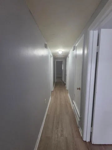 a view of hallway with wooden floor