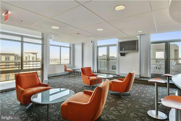 3600 South Glebe Road, Unit 601W Arlington, VA 22202 - Photo 20 of 23 a living room with furniture a rug and a floor to ceiling window