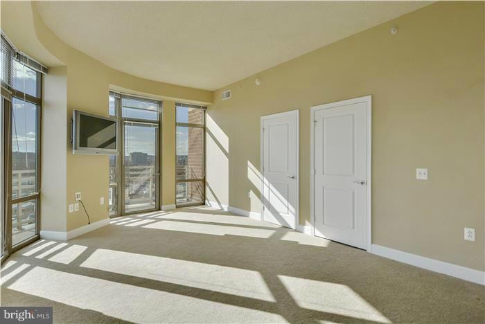 3600 South Glebe Road, Unit 601W Arlington, VA 22202 - Photo 6 of 23 a view of a livingroom with wooden floor and a ceiling fan
