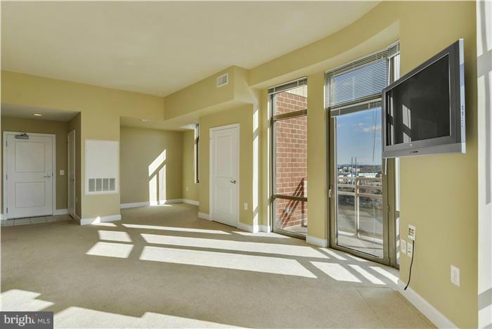 3600 South Glebe Road, Unit 601W Arlington, VA 22202 - Photo 9 of 23 a living room with hardwood floor and a flat screen tv