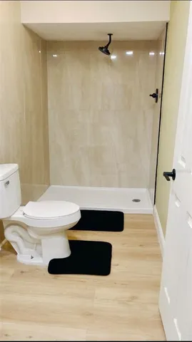 a bathroom with a toilet and a shower
