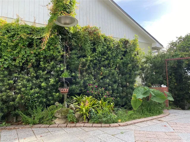 a backyard of a house with outdoor seating and plants