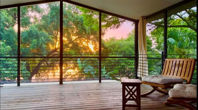 a view of a room with furniture and wooden floor