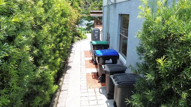 a view of a house with backyard and sitting area