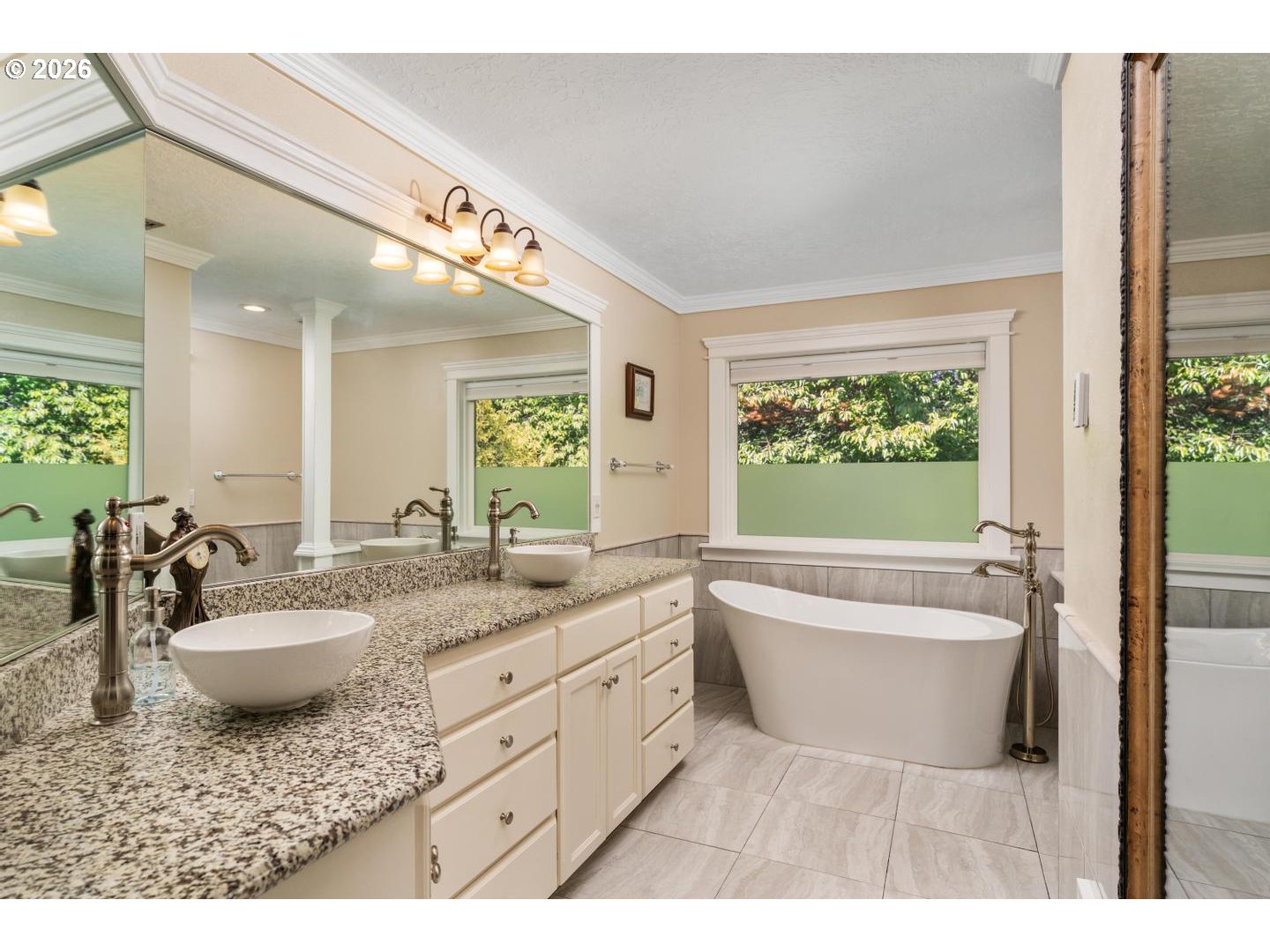 16042 Southwest Waxwing Way Beaverton, OR 97007 - Photo 24 of 48 a bathroom with a granite countertop sink mirror bathtub and next to a window
