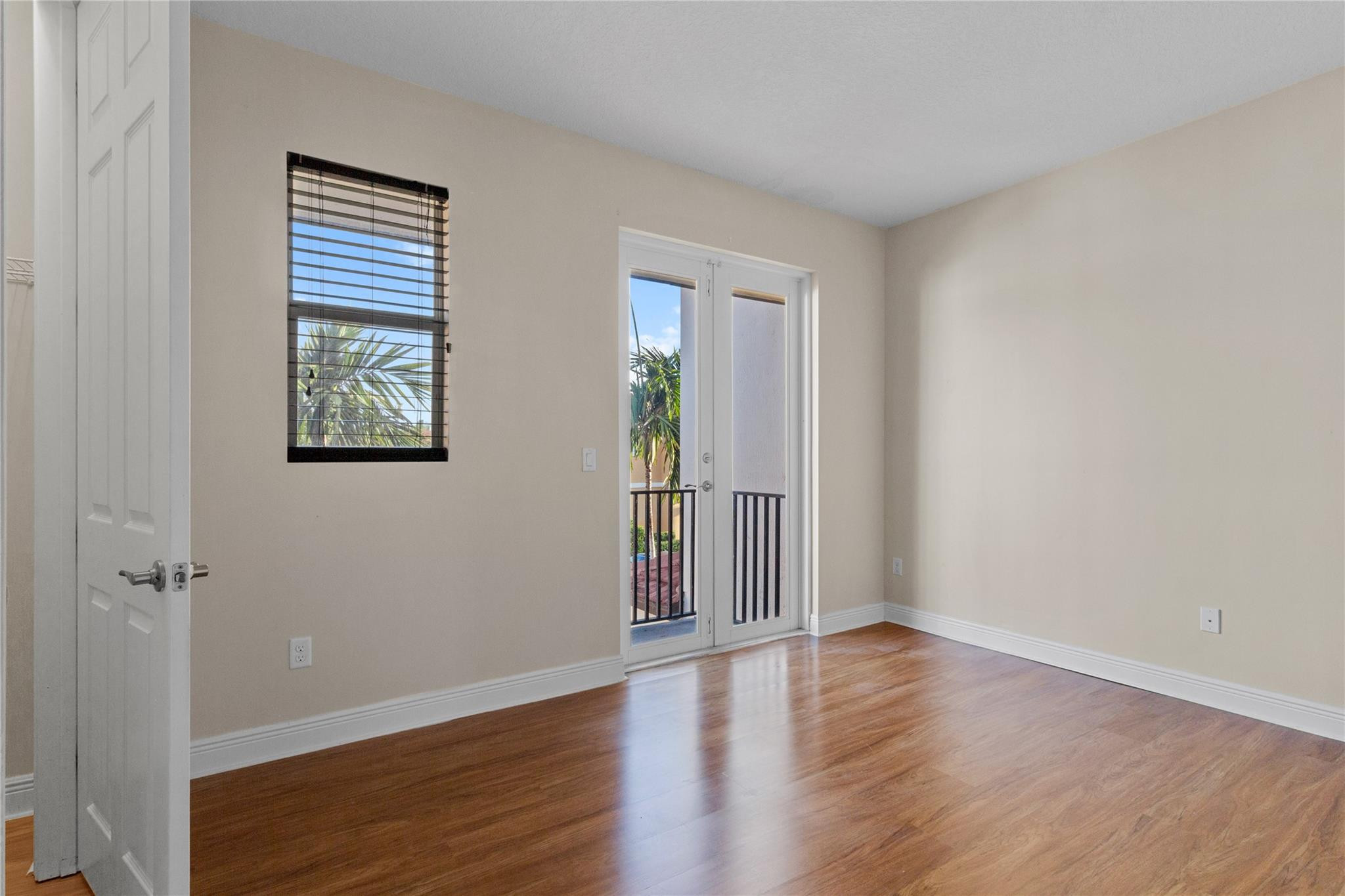 6918 Long Pine Circle Coconut Creek, FL 33073 - Photo 15 of 19 an empty room with wooden floor and windows