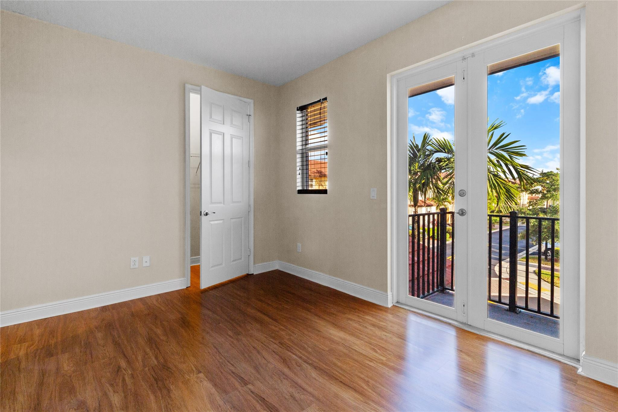 6918 Long Pine Circle Coconut Creek, FL 33073 - Photo 16 of 19 an empty room with wooden floor and windows