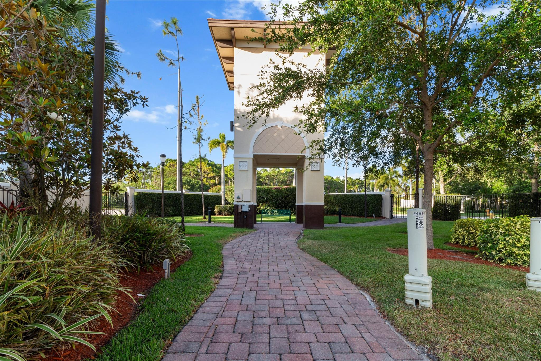 6918 Long Pine Circle Coconut Creek, FL 33073 - Photo 17 of 19 a view of a brick house with a big yard and large trees