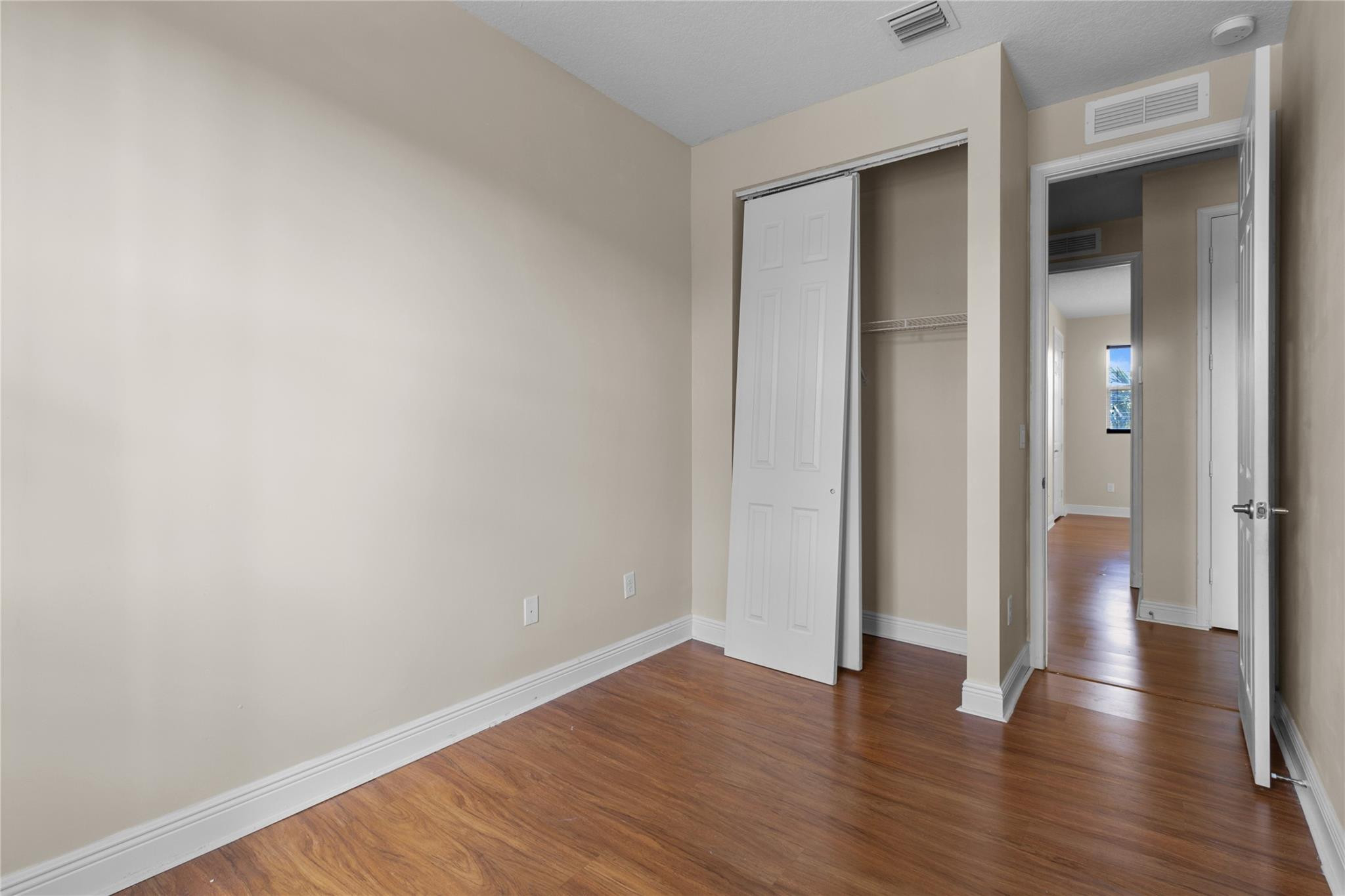 6918 Long Pine Circle Coconut Creek, FL 33073 - Photo 19 of 19 a view of an empty room with wooden floor and closet