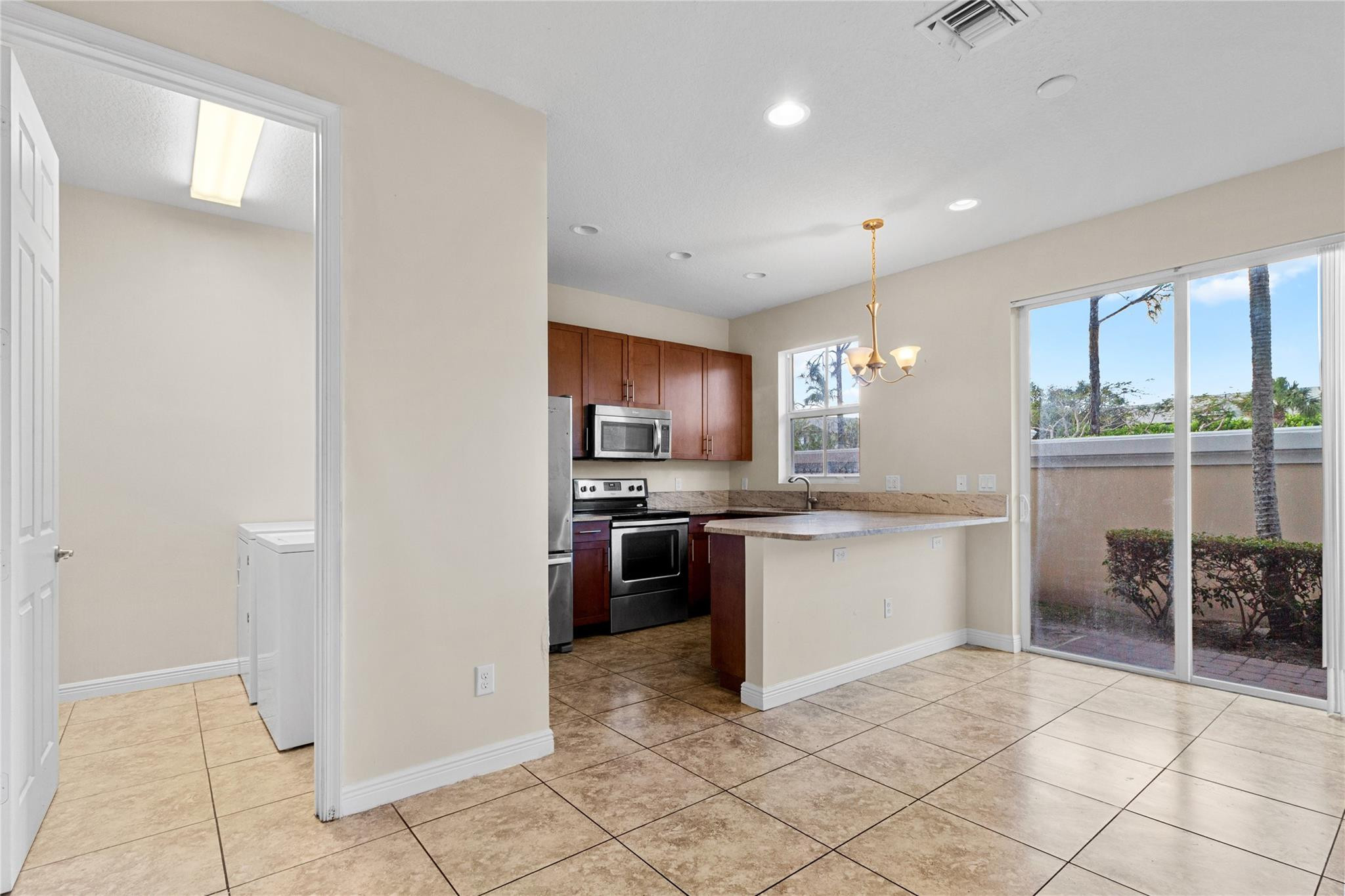 6918 Long Pine Circle Coconut Creek, FL 33073 - Photo 5 of 19 a kitchen with stainless steel appliances granite countertop a refrigerator and a sink