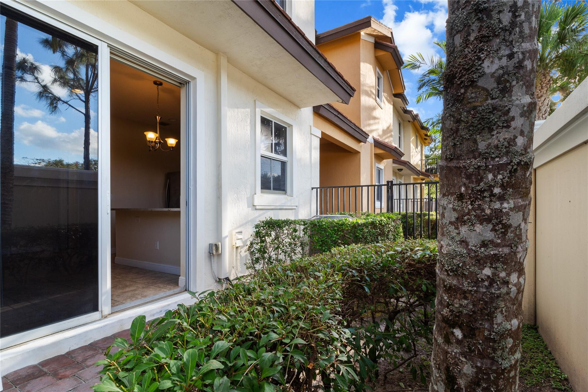 6918 Long Pine Circle Coconut Creek, FL 33073 - Photo 9 of 19 a view of a brick house with a small yard