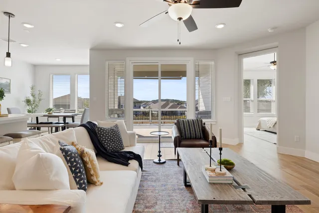a living room with furniture and floor to ceiling windows