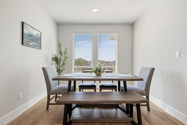 a view of a dining room with furniture window and wooden floor