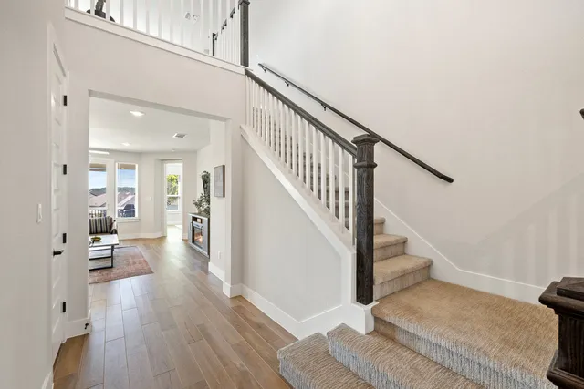 a view of entryway and hall with wooden floor
