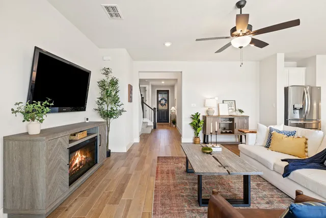 a living room with furniture a flat screen tv and a fireplace