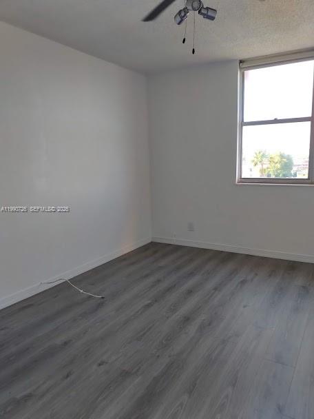 9001 Southwest 77th Avenue, Unit C604 Miami, FL 33156 - Photo 11 of 17 an empty room with wooden floor and windows