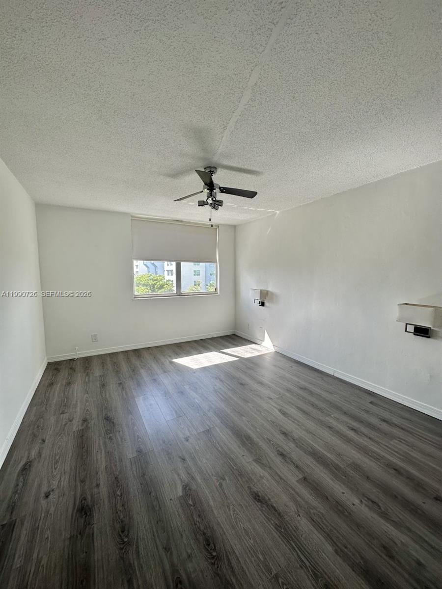 9001 Southwest 77th Avenue, Unit C604 Miami, FL 33156 - Photo 12 of 17 an empty room with wooden floor and windows