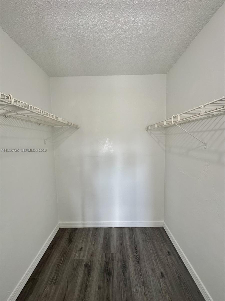 9001 Southwest 77th Avenue, Unit C604 Miami, FL 33156 - Photo 13 of 17 a view of an empty room with wooden floor and closet