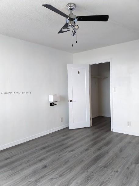 9001 Southwest 77th Avenue, Unit C604 Miami, FL 33156 - Photo 14 of 17 an empty room with wooden floor and windows