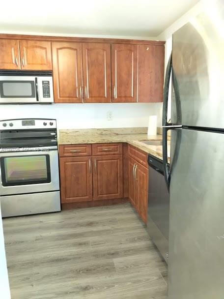 9001 Southwest 77th Avenue, Unit C604 Miami, FL 33156 - Photo 4 of 17 a kitchen with a sink appliances and cabinets