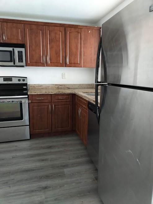 9001 Southwest 77th Avenue, Unit C604 Miami, FL 33156 - Photo 5 of 17 a kitchen with stainless steel appliances granite countertop a refrigerator a stove and a sink