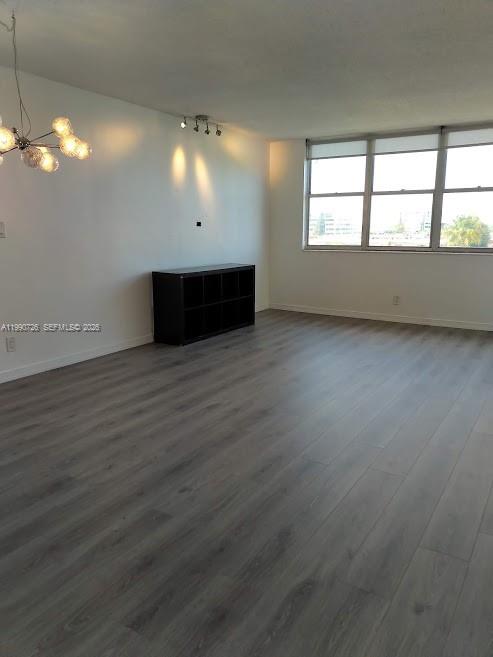 9001 Southwest 77th Avenue, Unit C604 Miami, FL 33156 - Photo 7 of 17 an empty room with wooden floor and windows