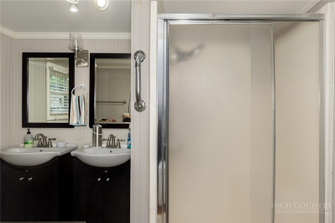 1335 Shingle Gap Road Purlear, NC 28665 - Photo 39 of 49 a bathroom with a double vanity sink and mirror