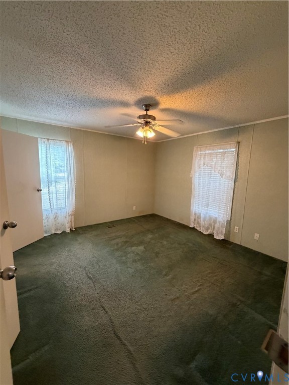 1292 Mt Prospect Road Laneview, VA 22504 - Photo 12 of 25 an empty room with a ceiling fan and window