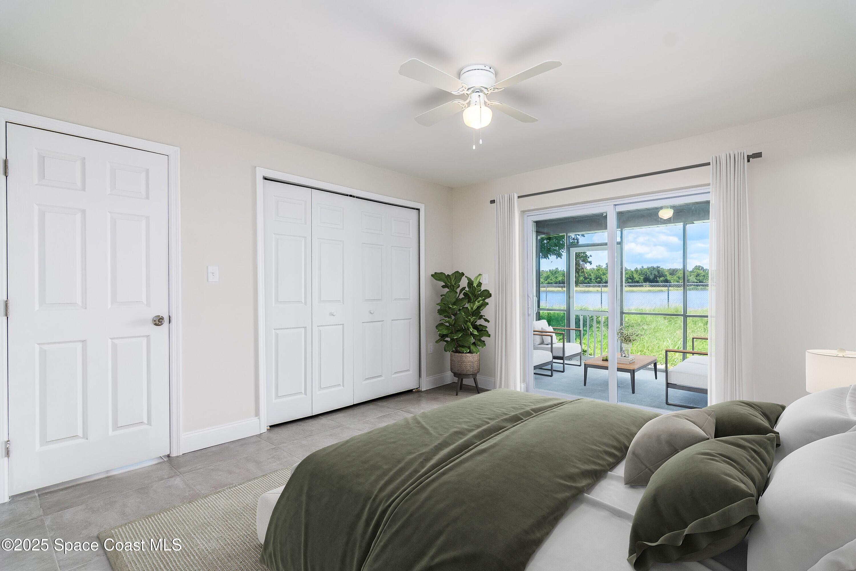 828 Angela Avenue, Unit A Rockledge, FL 32955 - Photo 14 of 31 a bed room with a bed and a large window