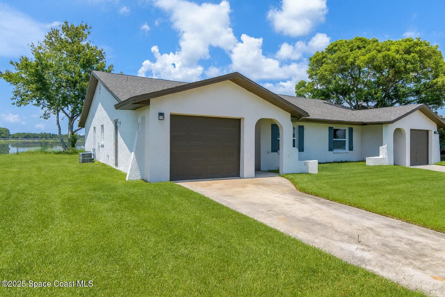 828 Angela Avenue, Unit A Rockledge, FL 32955 - Photo 2 of 31 a front view of house with yard and green space