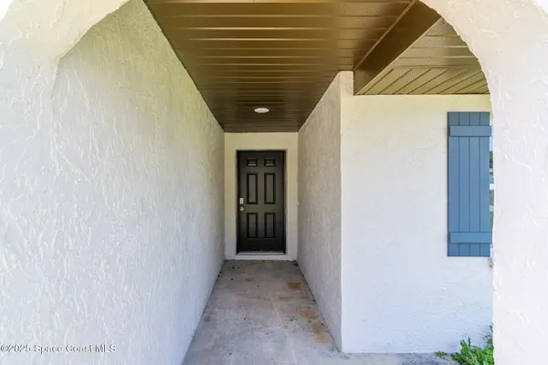 a view of a hallway with wooden wall