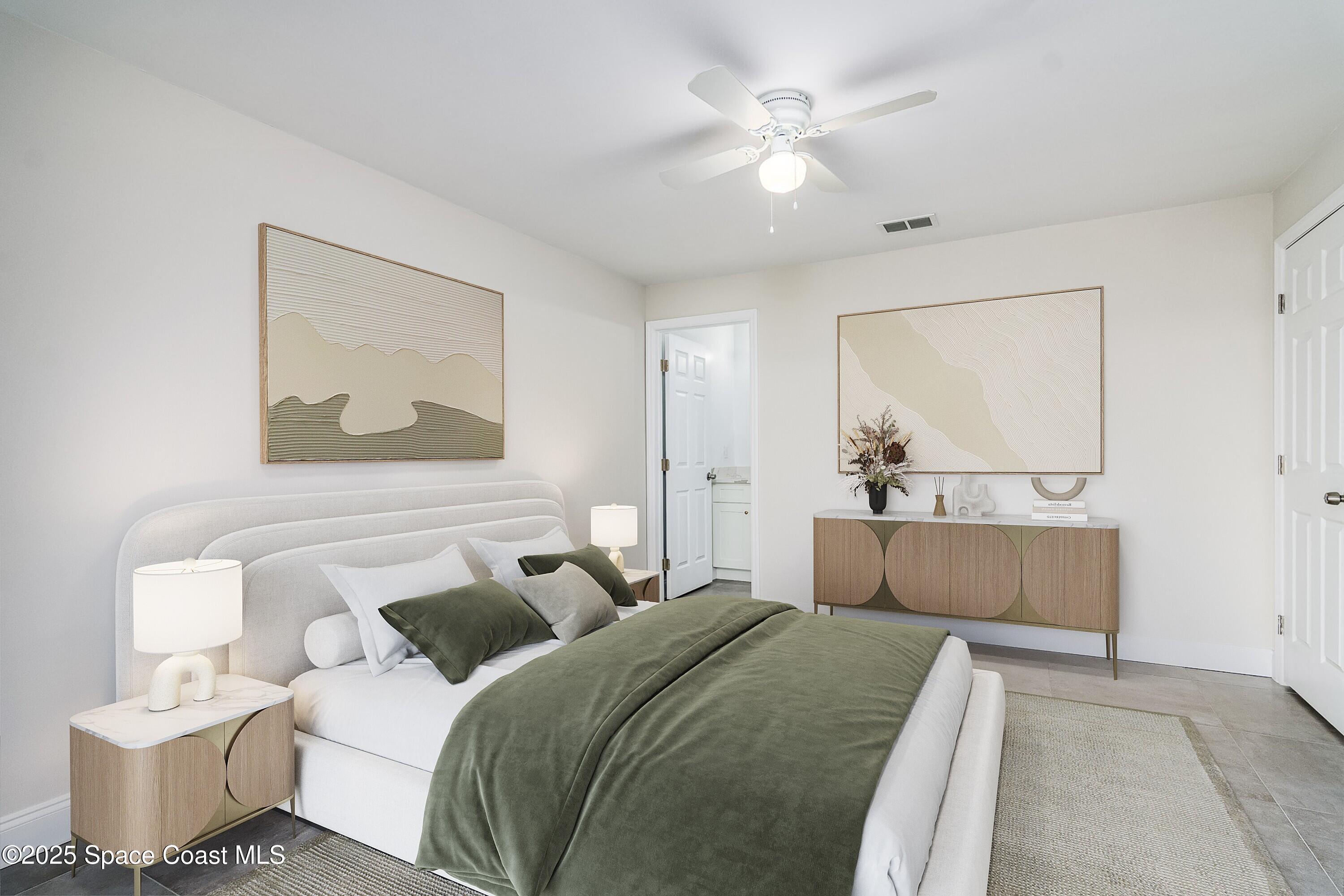 828 Angela Avenue, Unit A Rockledge, FL 32955 - Photo 10 of 31 a bedroom with a white bed and a chandelier