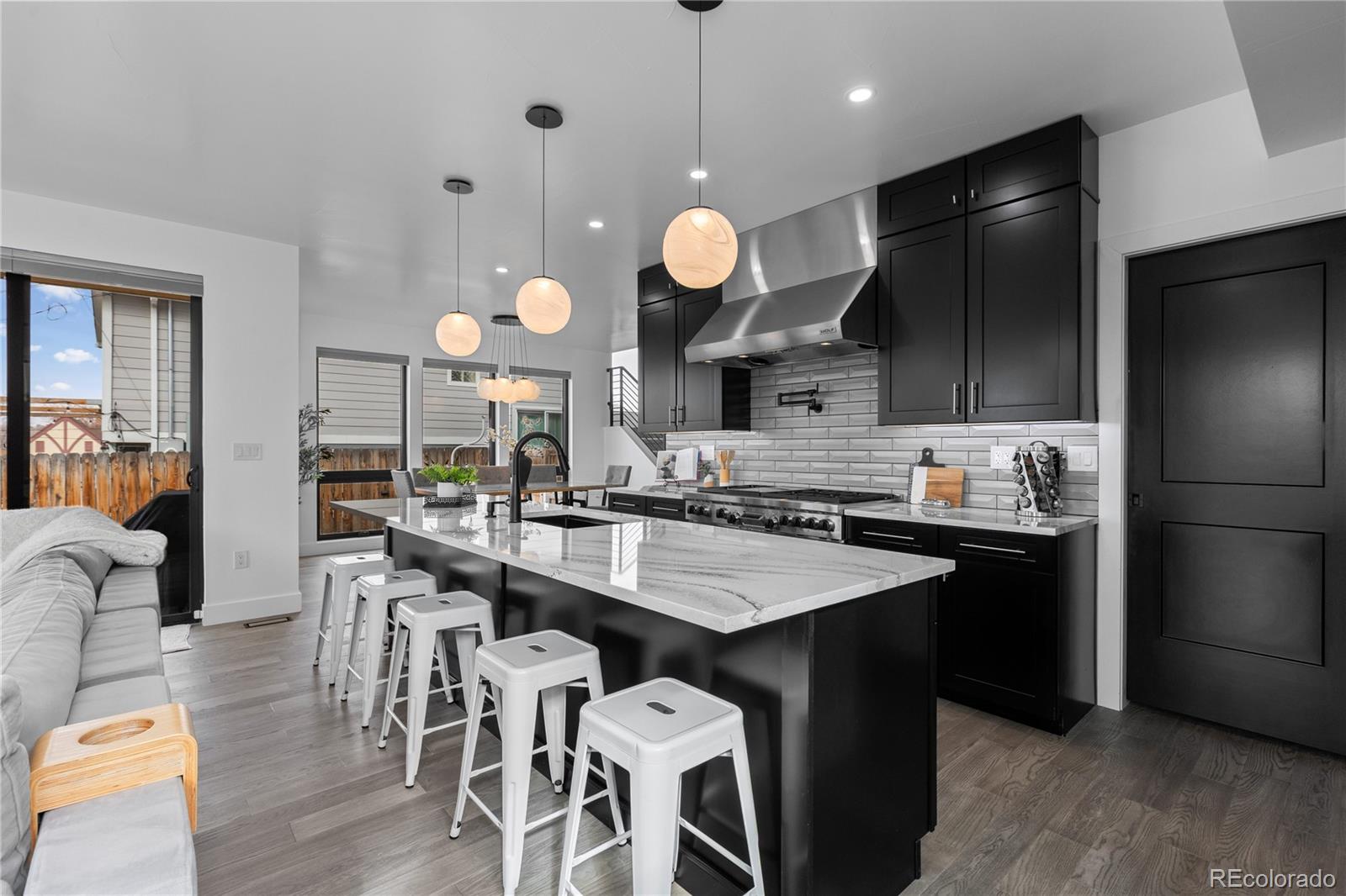1655 Wolff Street Denver, CO 80204 - Photo 14 of 50 a kitchen with a center island and stainless steel appliances