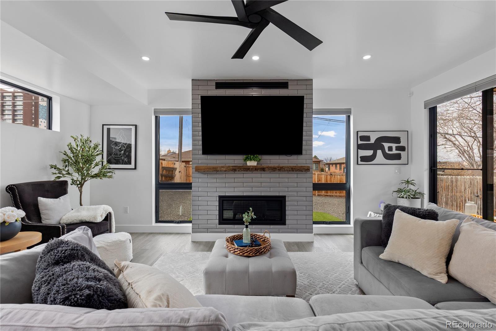 1655 Wolff Street Denver, CO 80204 - Photo 17 of 50 a living room with furniture a fireplace and a flat screen tv