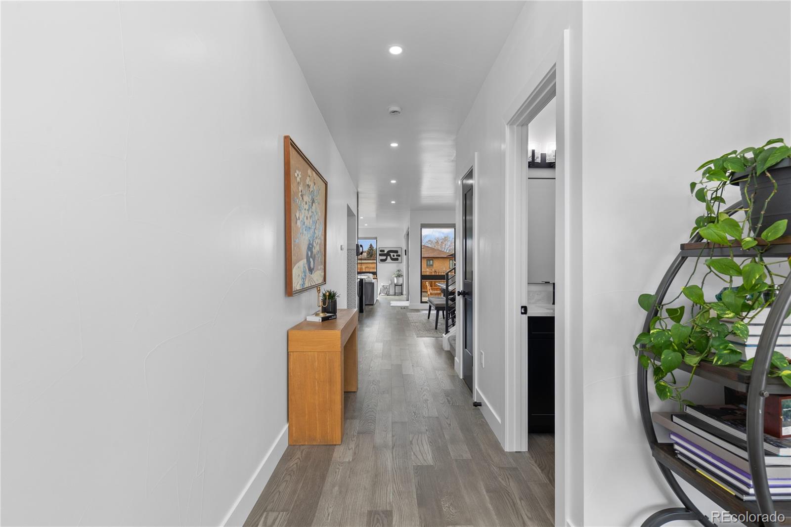 1655 Wolff Street Denver, CO 80204 - Photo 2 of 50 a view of a hallway with wooden floor windows and livingroom