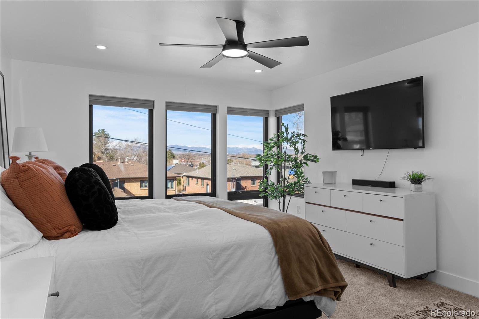 1655 Wolff Street Denver, CO 80204 - Photo 21 of 50 a bedroom with a large bed and a flat screen tv