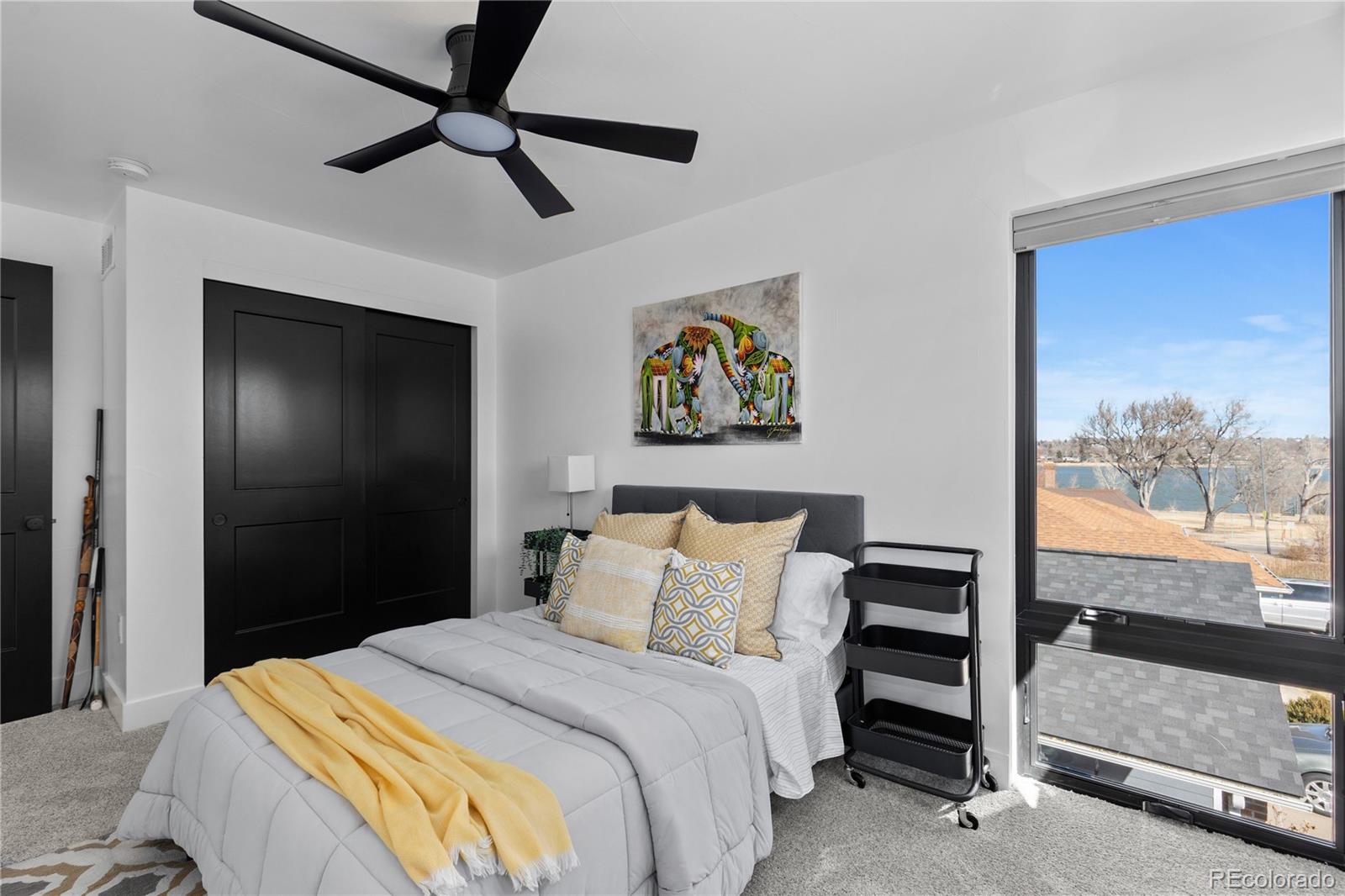 1655 Wolff Street Denver, CO 80204 - Photo 27 of 50 a bedroom with a bed and a painting on the wall