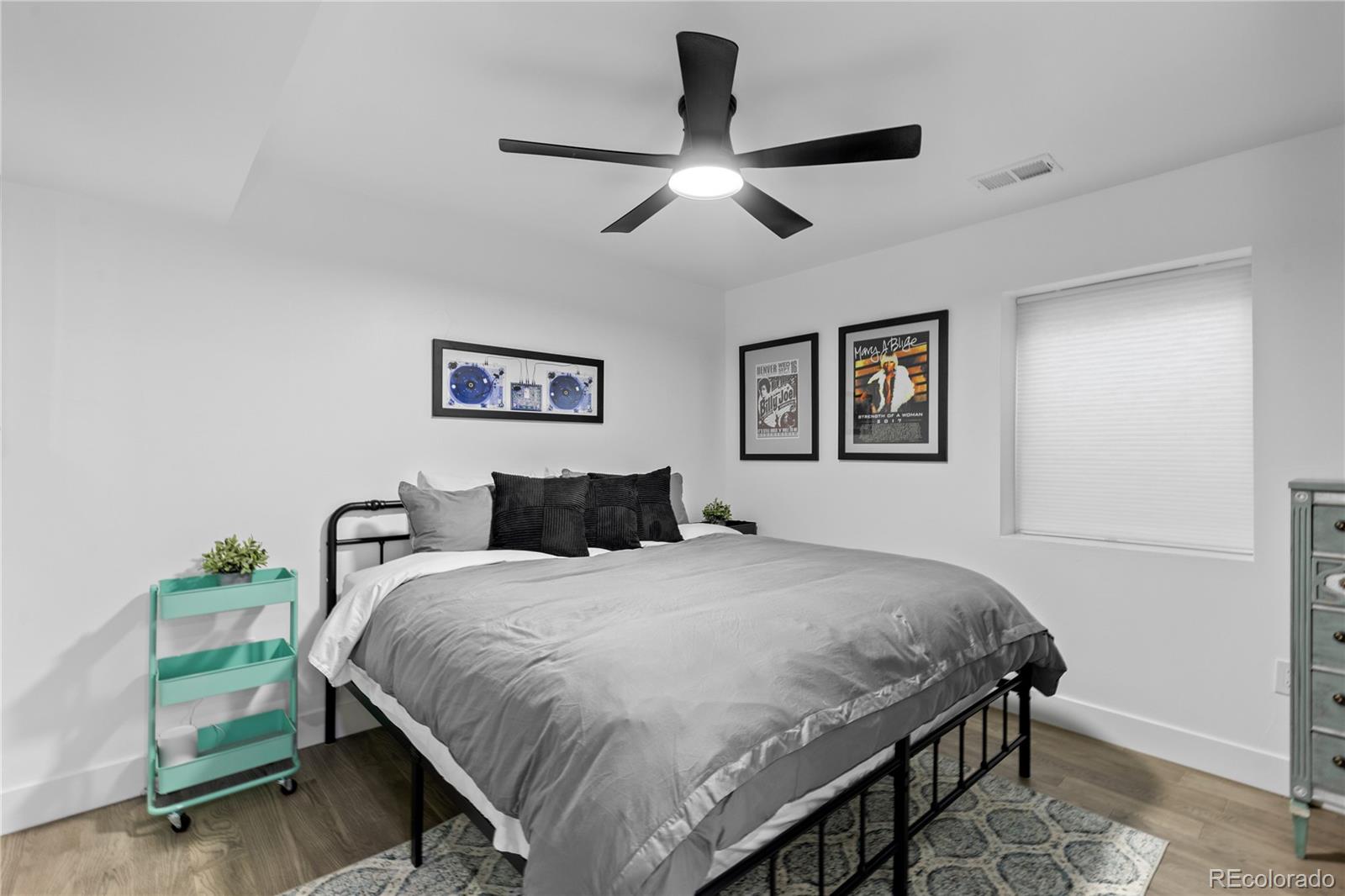1655 Wolff Street Denver, CO 80204 - Photo 46 of 50 a bedroom with a bed and a chandelier