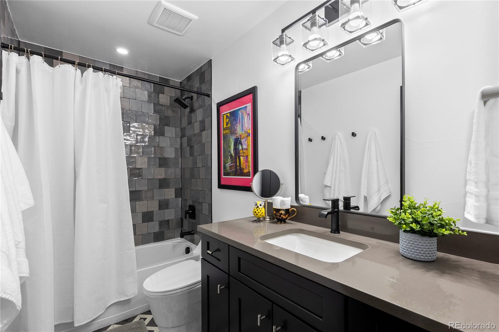 1655 Wolff Street Denver, CO 80204 - Photo 47 of 50 a bathroom with a granite countertop sink a toilet and shower