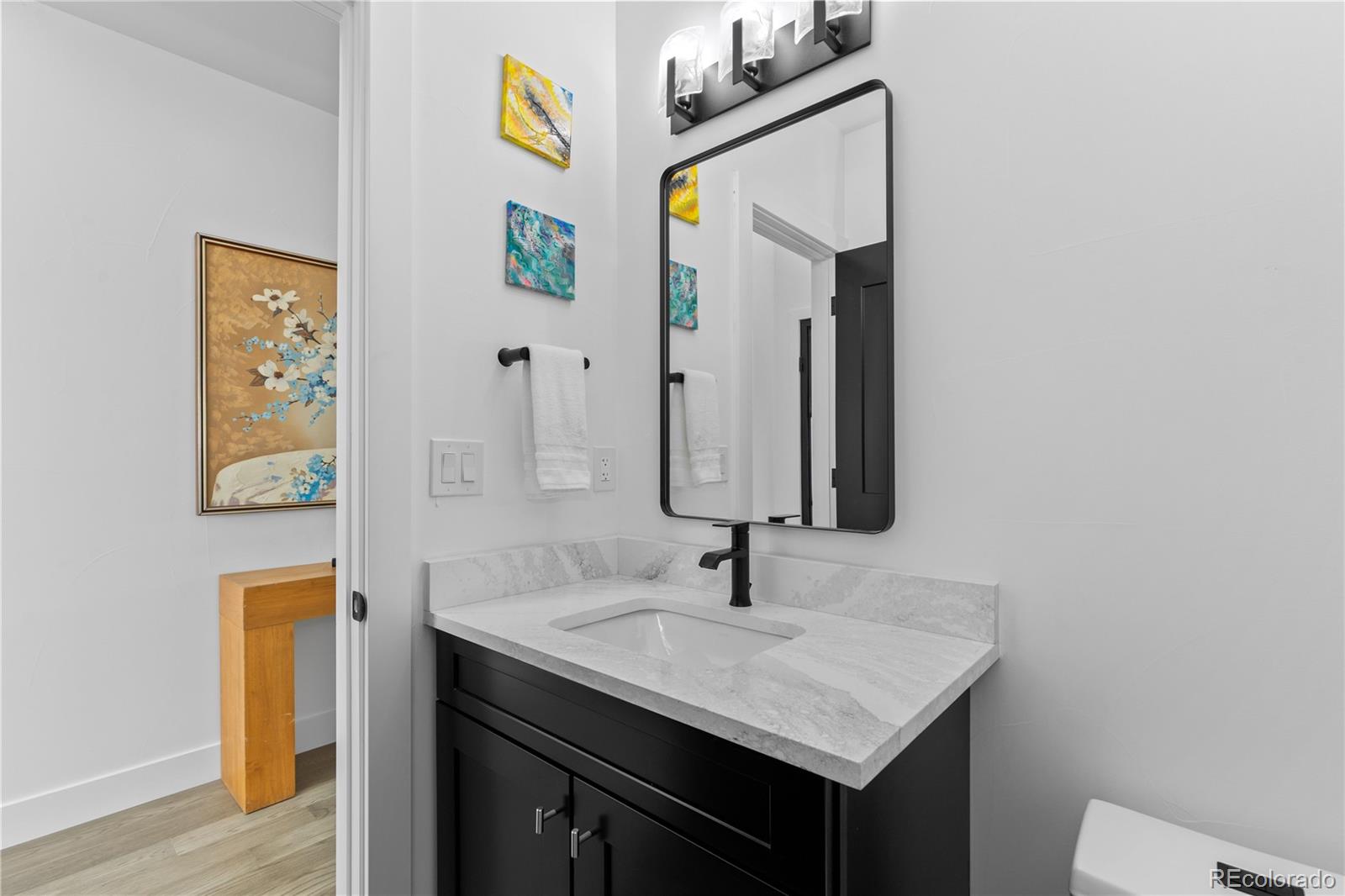 1655 Wolff Street Denver, CO 80204 - Photo 5 of 50 a bathroom with a sink and a mirror