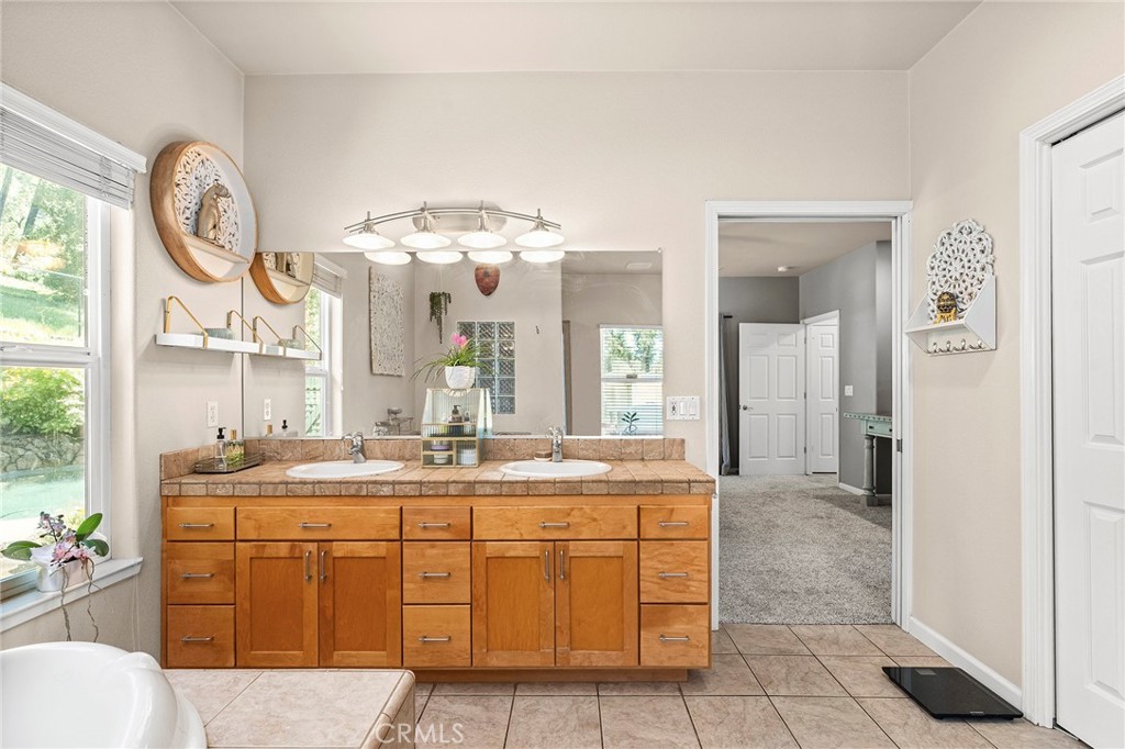 2262 Honey Run Road Chico, CA 95928 - Photo 16 of 74 a bathroom with a double vanity sink and a mirror