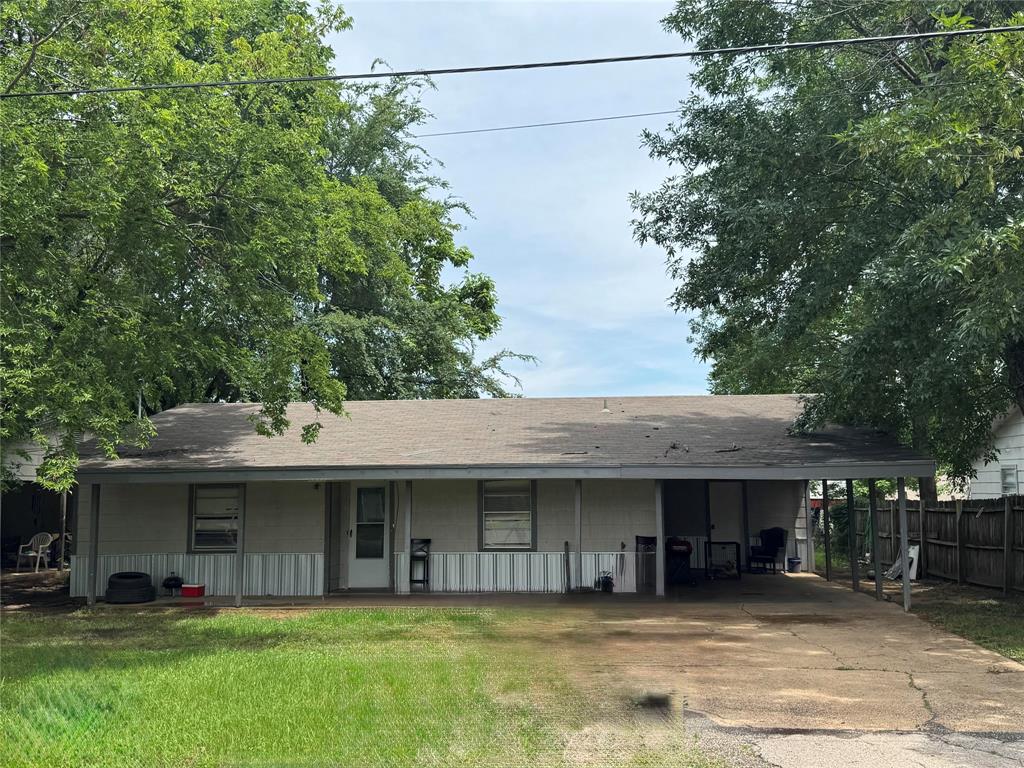4515 Southeast Loop 286 Paris, TX 75460 - Photo 24 of 37 a view of a house with a patio and a yard
