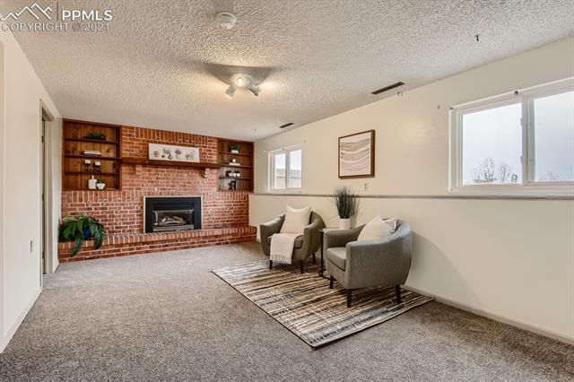5820 Garmish Road Colorado Springs, CO 80918 - Photo 10 of 23 Den with cozy brick wall