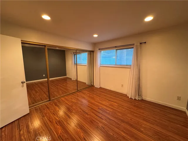 a white toilet sitting next to a shower