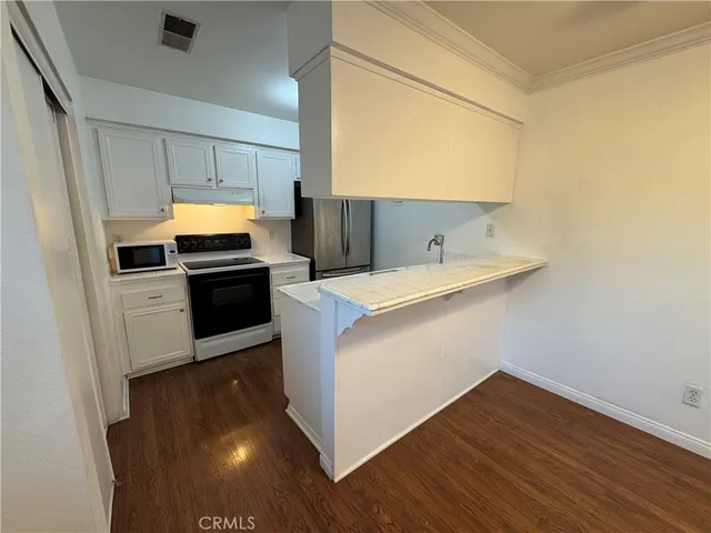 a kitchen with a refrigerator stove and microwave